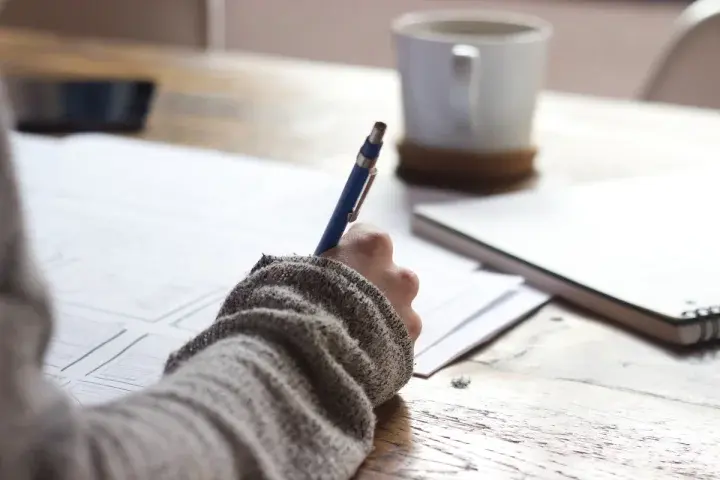 A person sitting down to write out their chatbot responses and program structure